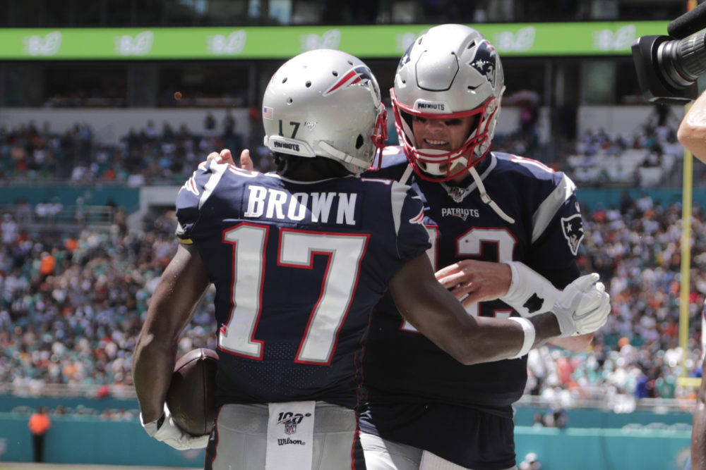 New England Patriots quarterback Tom Brady and wide receiver Antonio Brown celebrate after a touchdown in a game against the Miami Dolphins on Sunday. (Lynne Sladky/AP)