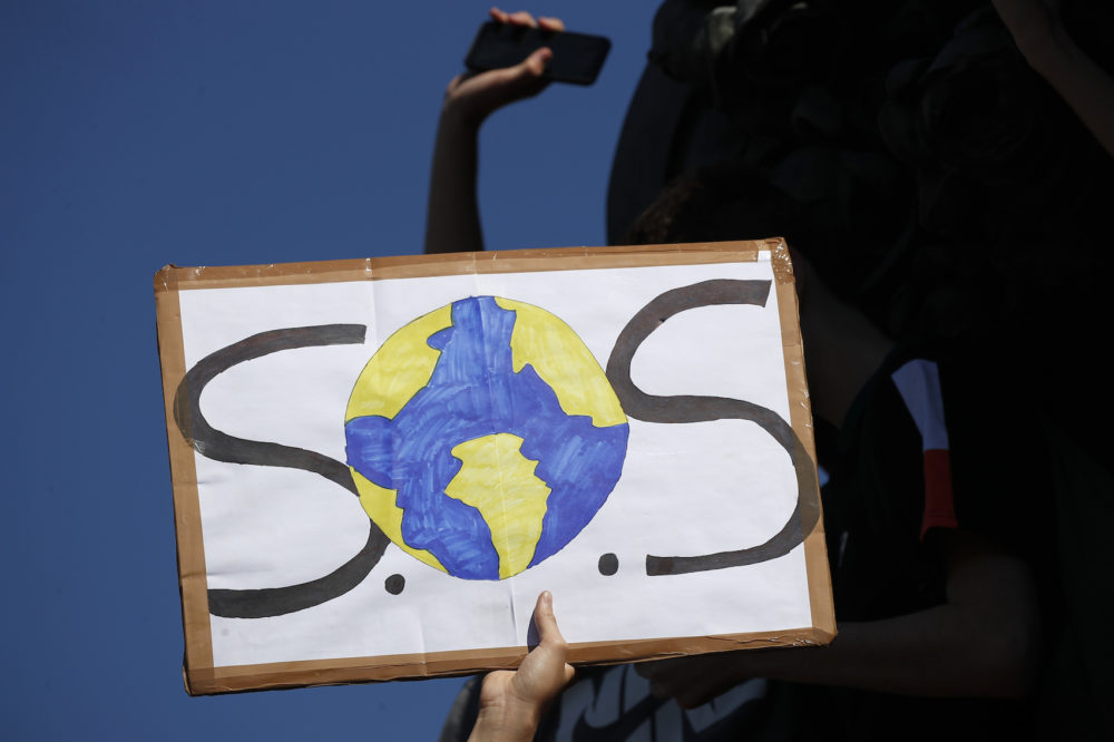 A protester shows a placard during a climate demonstration Friday, Sept. 20, 2019 in Paris. In Canberra and Kabul, Cape Town and Berlin, and across the globe, hundreds of thousands of people took the streets Friday to demand that leaders tackle climate change in the run-up to a U.N. summit. (Francois Mori/AP)