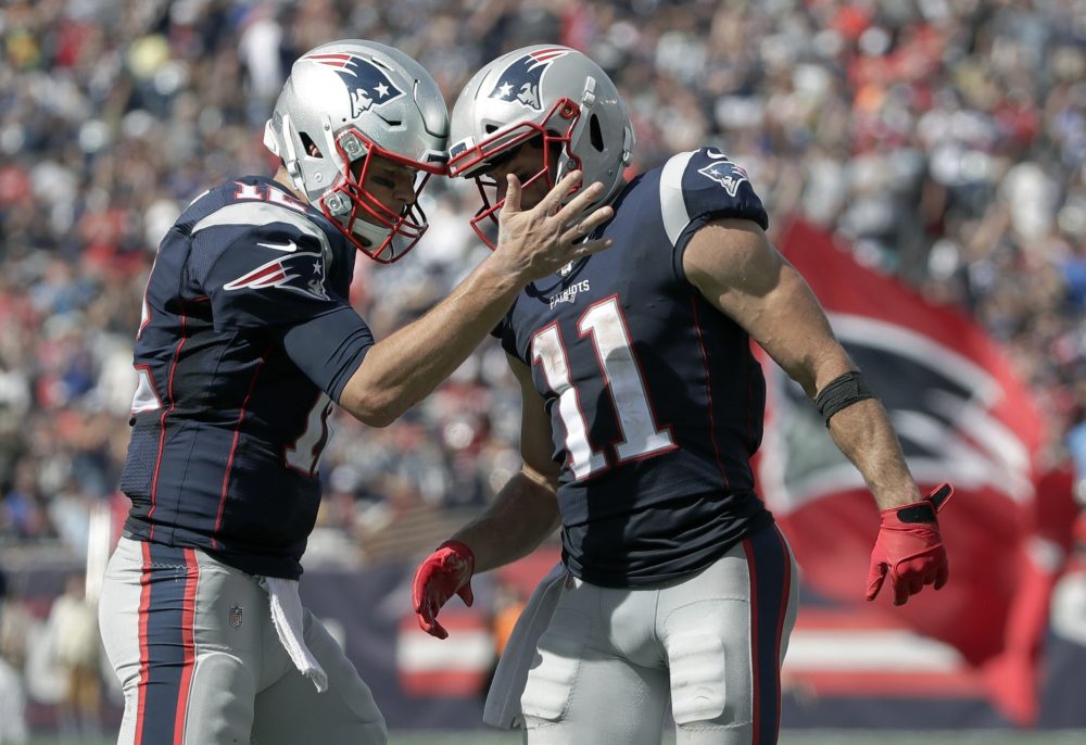 New England Patriots quarterback Tom Brady, left, celebrates his touchdown pass to Julian Edelman, right, in the first half of the game against the New York Jets on Sunday. (Elise Amendola/AP)