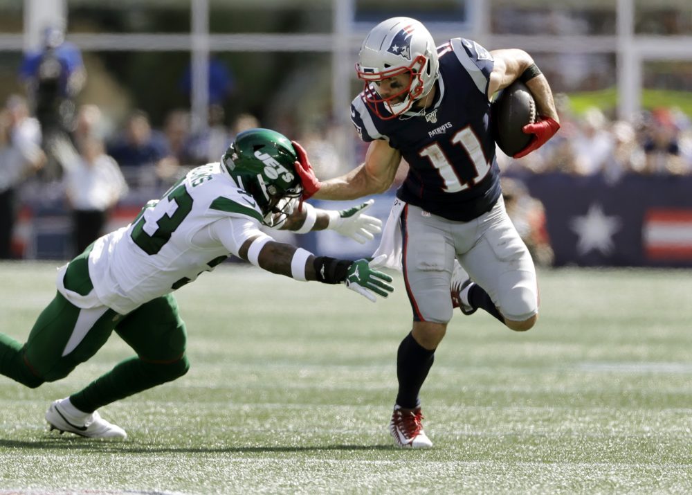 New England Patriots wide receiver Julian Edelman, right, tries to escape the grasp of New York Jets safety Jamal Adams in the first half ofteh game on Sunday. (Steven Senne/AP)