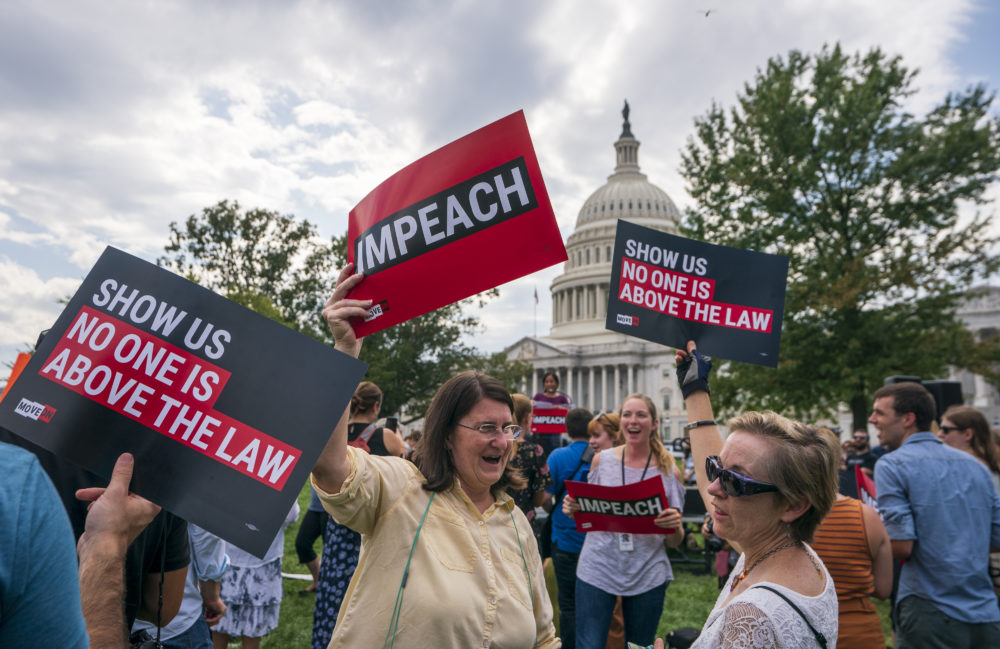 Activists rally for the impeachment of President Trump at the Capitol on Sept. 26. (J. Scott Applewhite/AP)