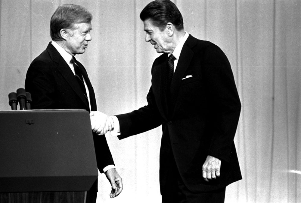 President Jimmy Carter and Republican presidential candidate Ronald Reagan shake hands in Cleveland, Ohio, before debating before a nationwide television audience. (AP file photo)