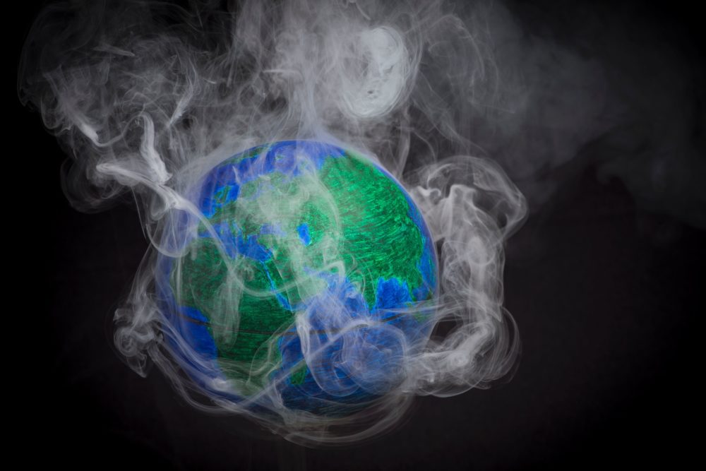 A picture taken on November 10, 2015 shows a small globe surrounded by smoke to illustrate global warming. (Lionel Bonaventure/AFP/Getty Images)