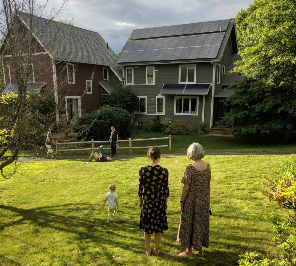 The author's daughter, wife and mother pictured in the foreground, looking at a neighbor's home in their cohousing community in central Massachusetts. (Courtesy)
