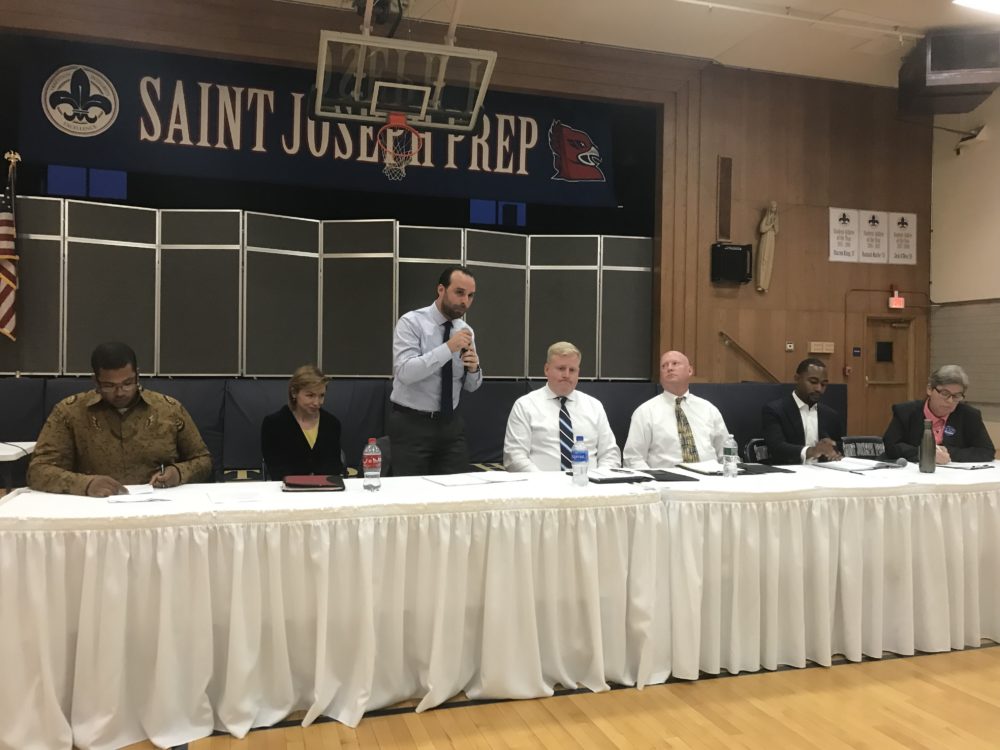 From left: Lee Nave Jr., Amanda Smart, Brandon Bowser, Craig Cashman, Dan Daly, Jonathan Allen and Liz Breadon at a recent debate in Brighton (Walter Wuthmann/WBUR)