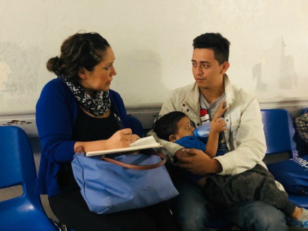 In this March 2019 photo, the author interviews a young father from Nicaragua at the Humanitarian Respite Center in McAllen, Texas. (Photo by Angelica Maria Garcia)