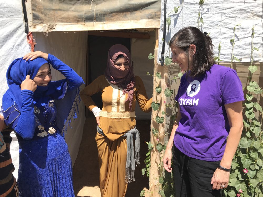 The author, pictured right, visits refugees in Bekaa Valley in Lebanon in July 2019. She is speaking with two young Syrian women who have been living in Lebanon since the beginning of the Syrian crisis. (Lauren Hartnett/Oxfam)