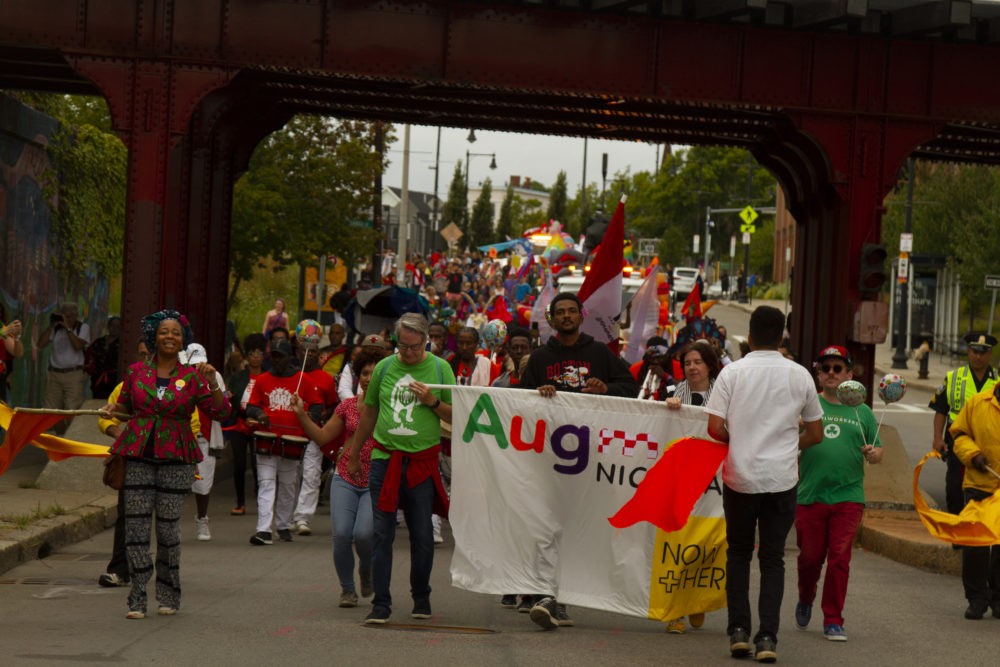 The parade makes it under the Upham's Corner Commuter Rail overpass. (Photo by Chris Rogers)