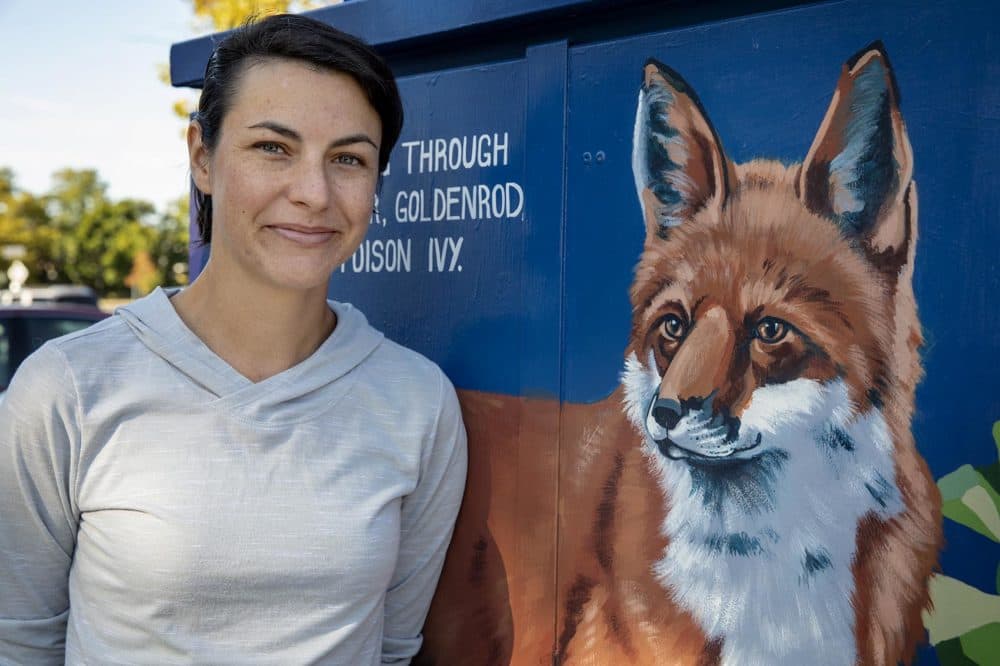 Artist Sophy Tuttle in front of her painting &quot;Red Fox &amp; Blue Wood Aster.&quot; (Robin Lubbock/WBUR)