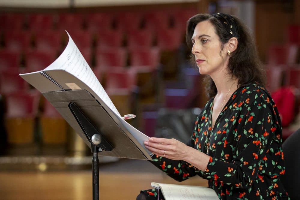 Composer Dalit Warshaw turns a page of &quot;Sirens: A Concerto for Theremin and Orchestra&quot; as she listens to the Boston Modern Orchestra Project rehearsing the piece. (Robin Lubbock/WBUR)