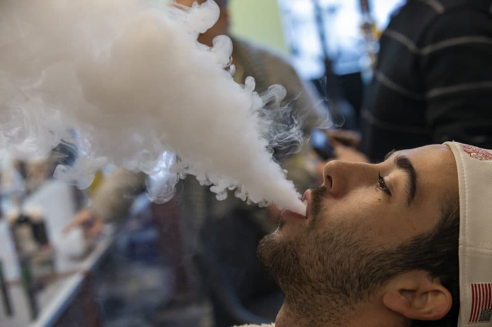 Ethan Woodman of Methuen, Mass., tests out a SMOK Species vaping device at Smoker Choice in Salem,. N.H. (Jesse Costa/WBUR)