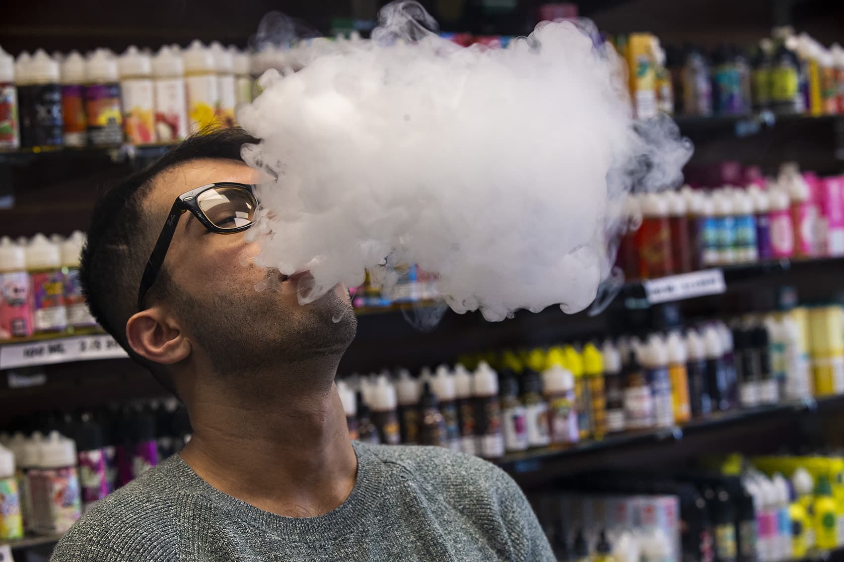 Ali Shaikh, manager of Smoker Choice in Salem, N.H., demonstrates the SMOK Species vaping device. (Jesse Costa/WBUR)