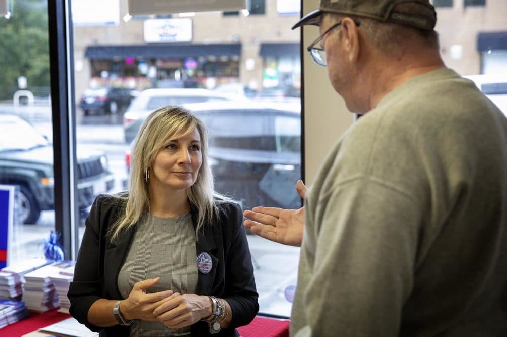 District 5 council candidate Maria Esdale Farrell talks with supporter Dan O’Connor at her campaign office in Hyde Park. (Robin Lubbock/WBUR)