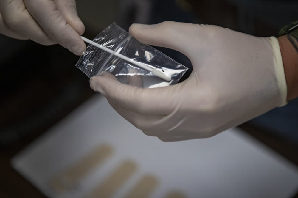 A swab is used to take an initial trace sample of the substance in the bag. (Jesse Costa/WBUR)