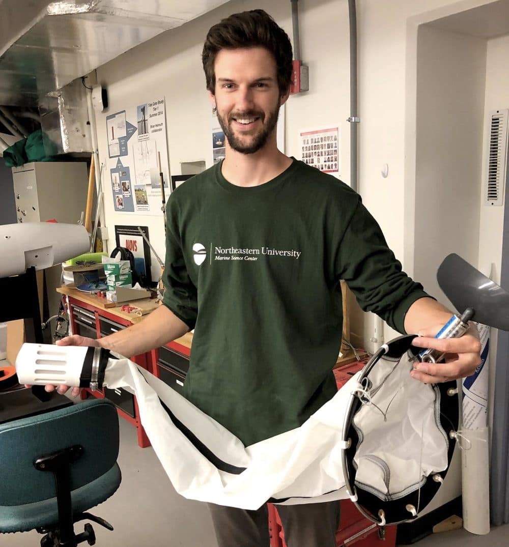 Ethan Edson, Research Administrator at the Northeastern University Marine Science Center, holds &quot;MantaRay&quot;, an sensor that one day could measure microplastic pollution below the surface of the ocean. (Barbara Moran/WBUR)