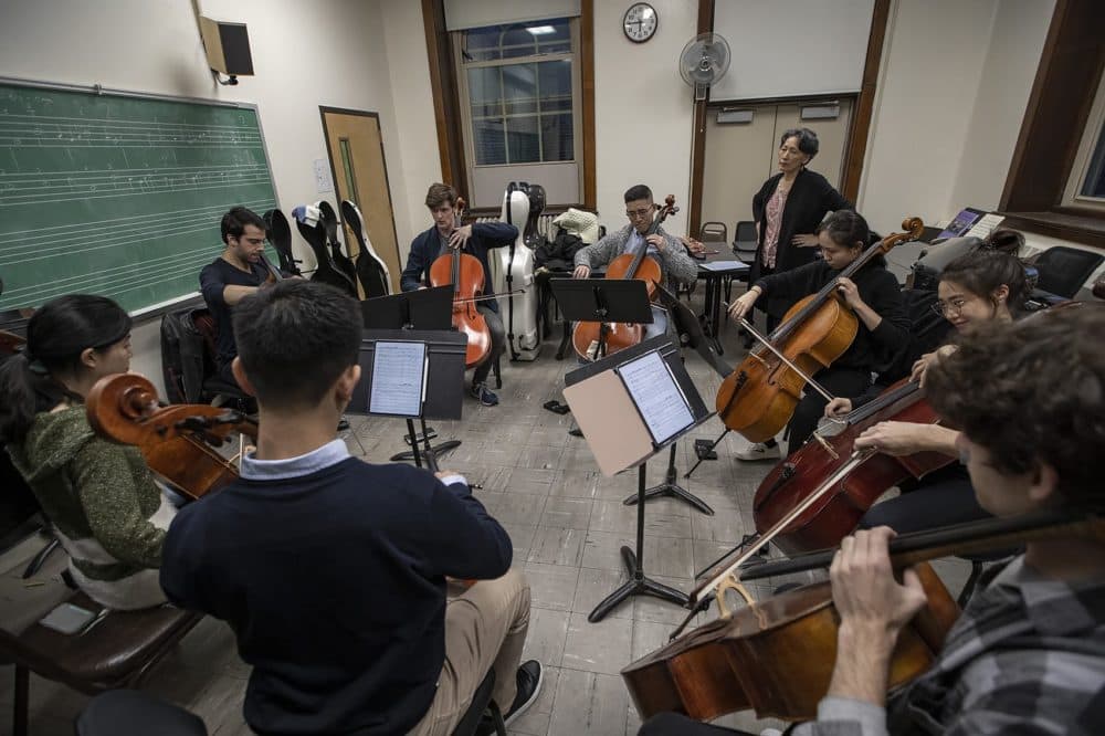 During a recent rehearsal at the New England Conservatory, Yeesun Kim listens to students who will be part of a 56 cello orchestra playing the Bach Cello Suites for a tribute to Pablo Casals. (Jesse Costa/WBUR)
