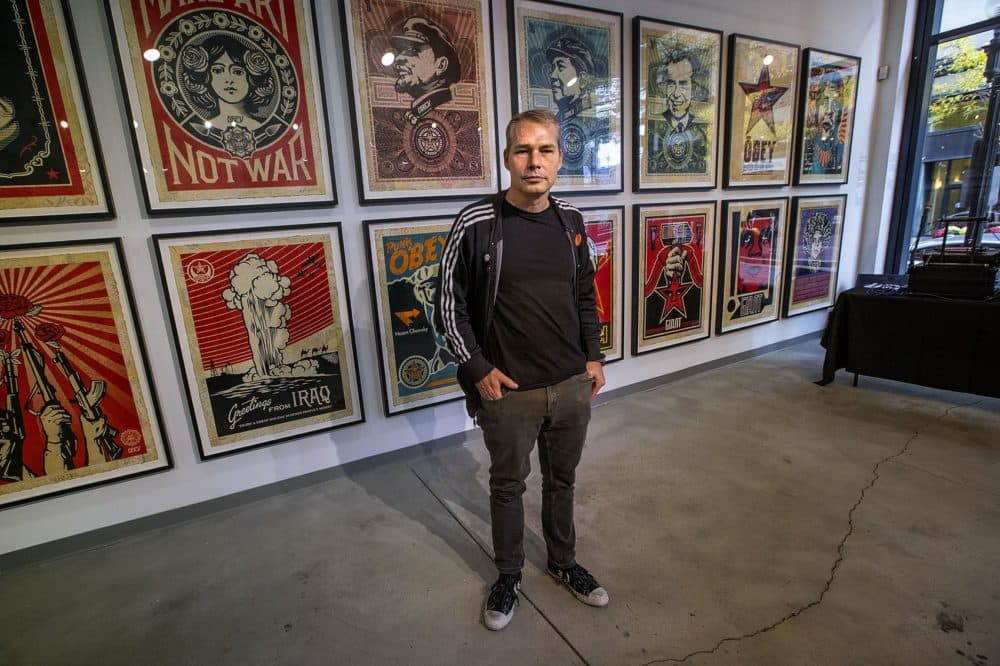 Shepard Fairey stands in front of his work at a pop-up gallery at 233 Westminster St. in Providence. (Jesse Costa/WBUR)