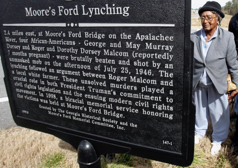 Rosa Ingram, Roger Malcom's aunt, reads the Georgia Historical Society marker for the Moore's Ford bridge lynching on the turnoff from Hwy. 78 at the rural bridge outside Monroe, Ga., Saturday, Feb. 12, 2005. On July 25, 1946, George Dorsey, Mae Murray Dorsey, Roger Malcom and Dorothy Malcom were lynched by a mob on the bridge that spanned the Apalachee River some 60 miles from Atlanta. No one has ever been charged in the murders. (Ric Feld/AP)