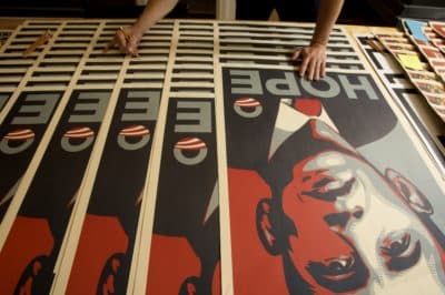 Los Angeles street artist Shepard Fairey signs his Barack Obama Hope artwork on Jan. 12, 2009. (Damian Dovarganes/AP)