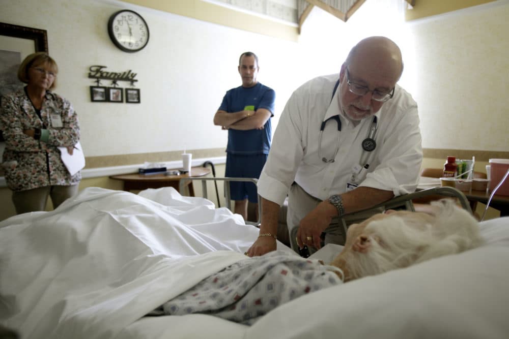 Dr. Joel Policzer checks on his patient in this Oct. 30, 2009 photo, in the hospice wing of an Oakland Park, Fla. hospital. (J Pat Carter/AP)