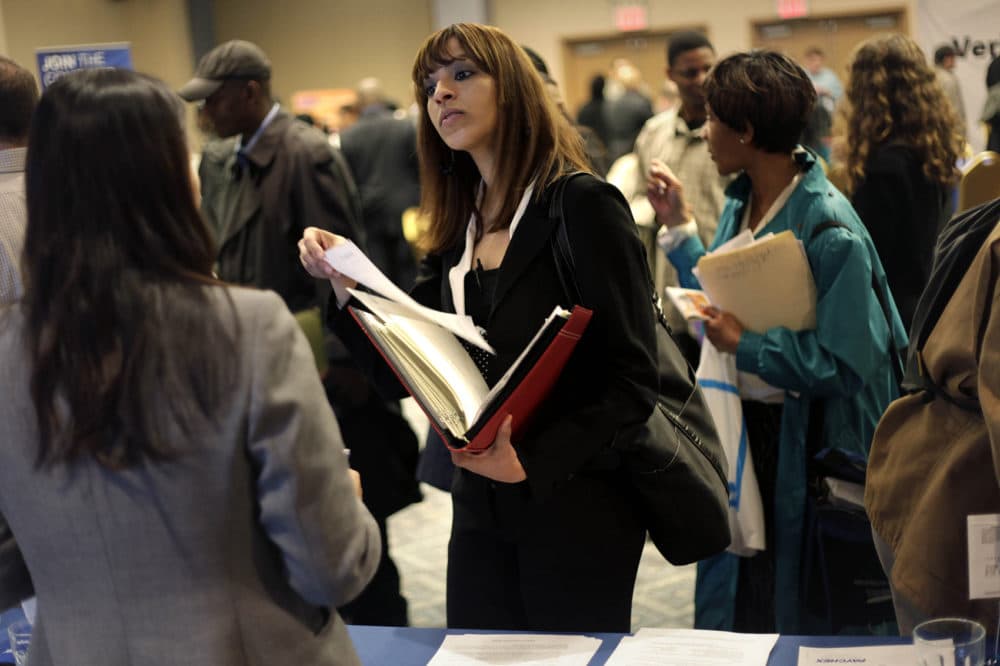 A woman at a job fair in New York talks to an employer. (Seth Wenig, File/AP)