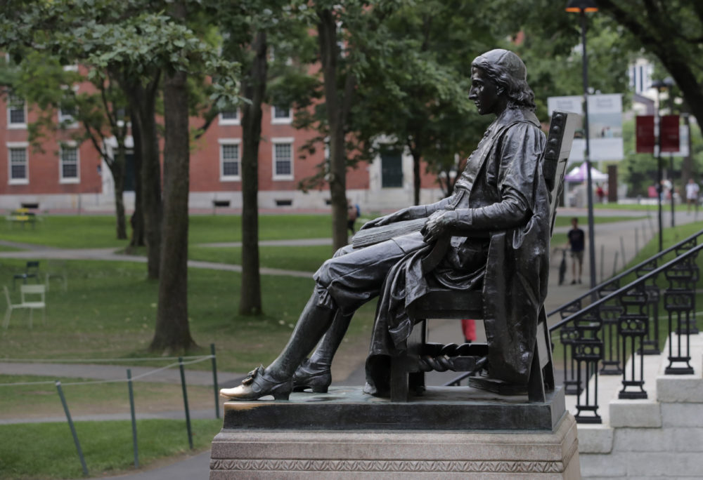 The statue of John Harvard in Harvard Yard at Harvard University (Charles Krupa/AP).