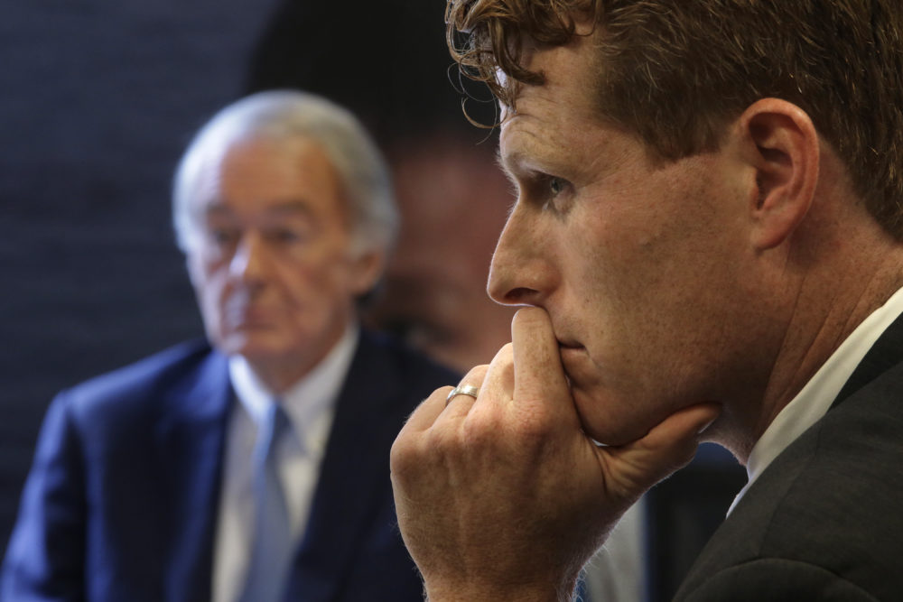 U.S. Sen. Edward Markey, D-Mass., left, and U.S. Rep. Joseph Kennedy III, D-Mass., listen during a roundtable discussion Tuesday in Boston, on the impact of a cap on refugee admissions to the U.S. for fiscal 2020. (Steven Senne/AP)