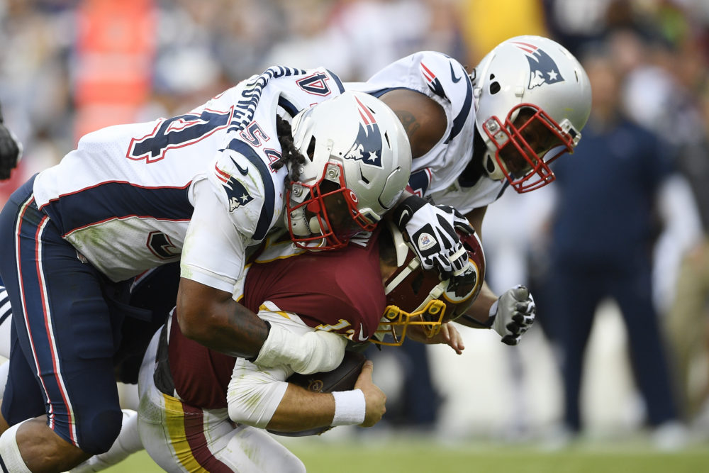 New England Patriots outside linebacker Dont'a Hightower (54) and New England Patriots defensive end Michael Bennett (77) sack Washington Redskins quarterback Colt McCoy (12) during the second half of the game Sunday. (Nick Wass/AP)
