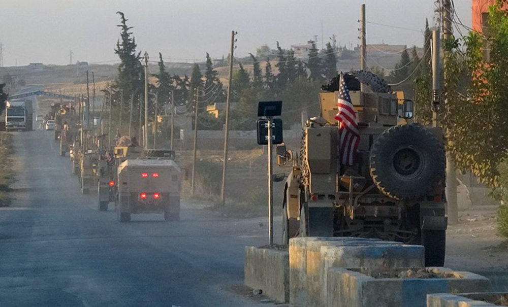 In this image provided by Hawar News Agency, ANHA, U.S. military vehicles travel down a main road in northeast Syria, Monday, Oct. 7, 2019. (ANHA /AP)