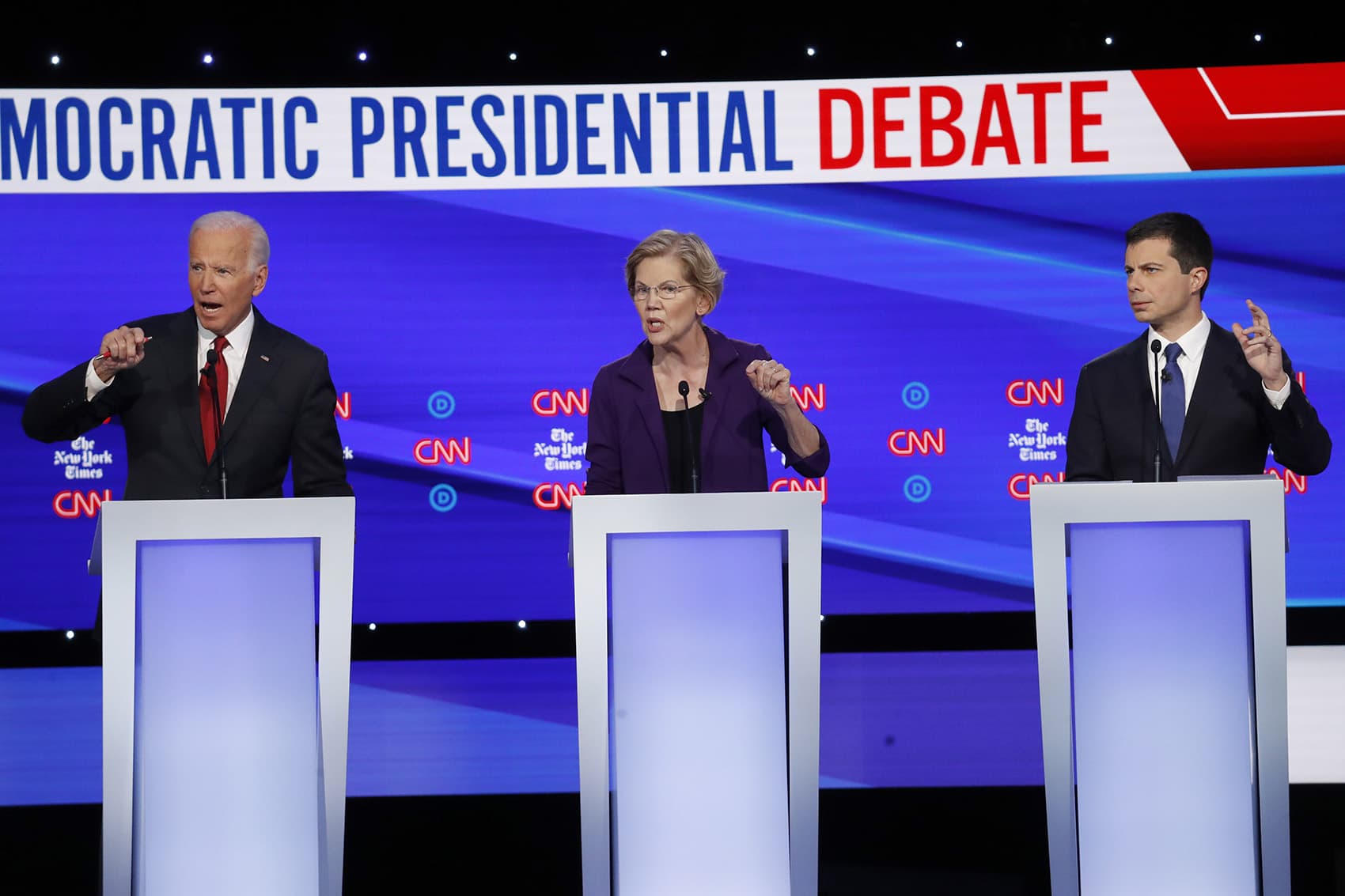Democratic presidential candidate former Vice President Joe Biden, left, Sen. Elizabeth Warren, D-Mass., center and South Bend Mayor Pete Buttigieg speak during a Democratic presidential primary debate hosted by CNN/New York Times at Otterbein University, Tuesday, Oct. 15, 2019, in Westerville, Ohio. (John Minchillo/AP)