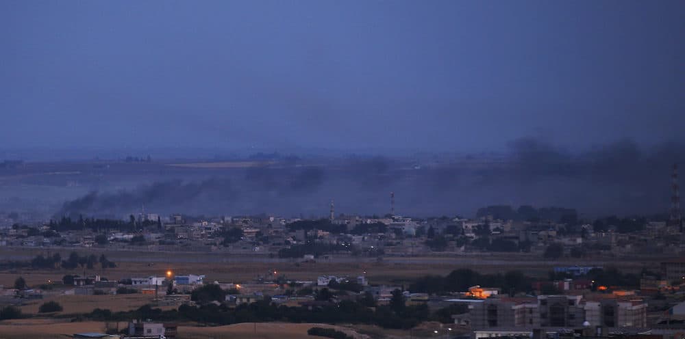 In this photo taken from the Turkish side of the border between Turkey and Syria, in Ceylanpinar, Sanliurfa province, southeastern Turkey, smoke billows from targets in Ras al-Ayn, Syria, caused by shelling by Turkish forces, late Wednesday, Oct. 16, 2019. (Lefteris Pitarakis/AP)