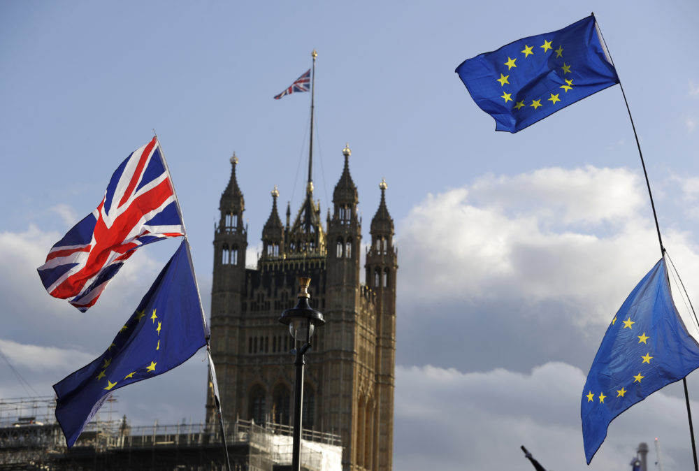 Union Jacks and EU flags fly over Britain's Parliament in Londonn. (Kirsty Wigglesworth/AP)