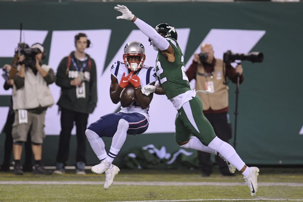 Patriots' Phillip Dorsett, left, catches a pass for a touchdown in front of New York Jets' Trumaine Johnson during the first half of the game. (Bill Kostroun/AP)