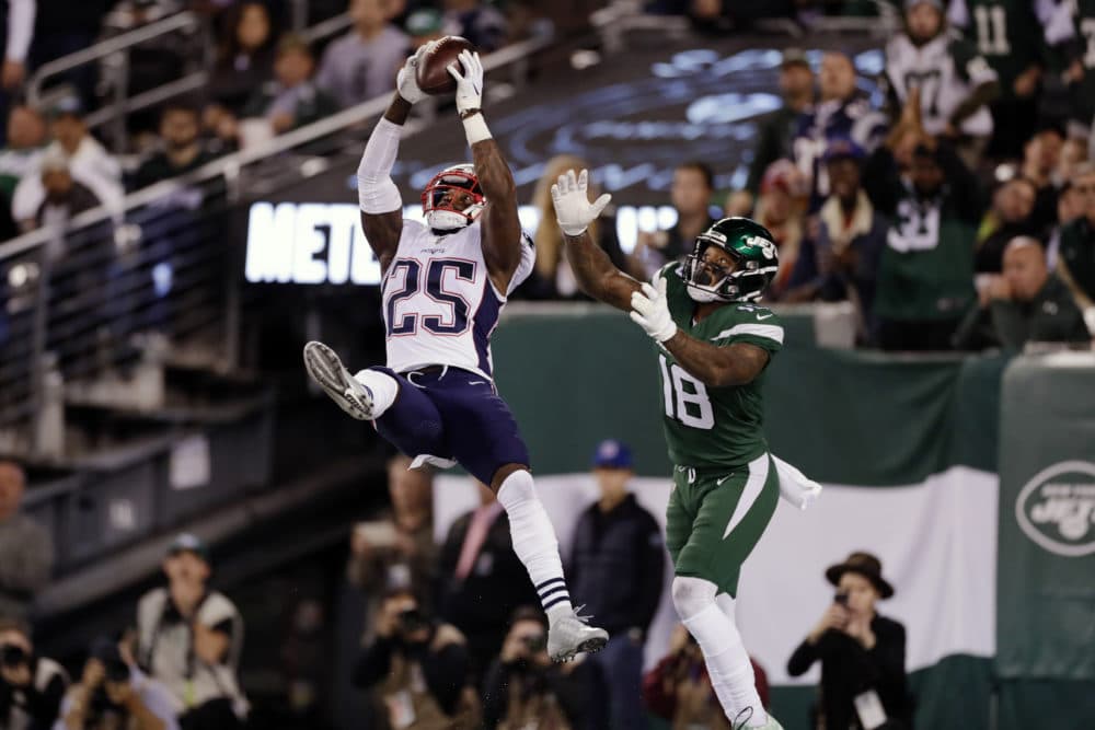 New England Patriots' Terrence Brooks (25) intercepts a pass to New York Jets' Demaryius Thomas (18) during the second half of the game, Oct. 21, 2019, in East Rutherford, N.J. (Adam Hunger/AP)