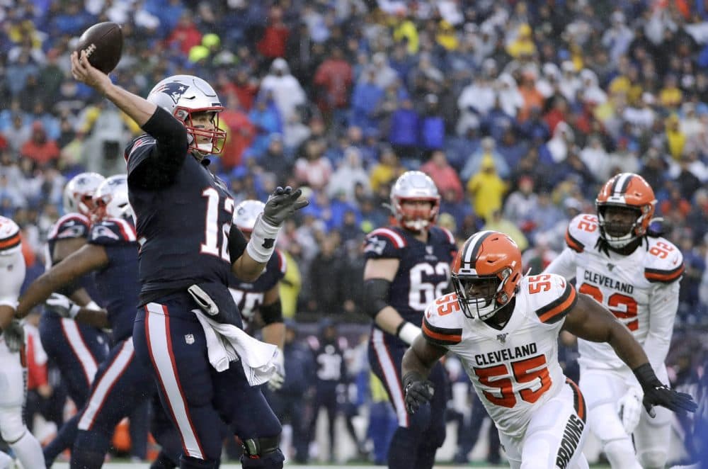 Patriots quarterback Tom Brady passes under pressure from Browns linebacker Genard Avery (55) in the first half of the game. (Steven Senne/AP)