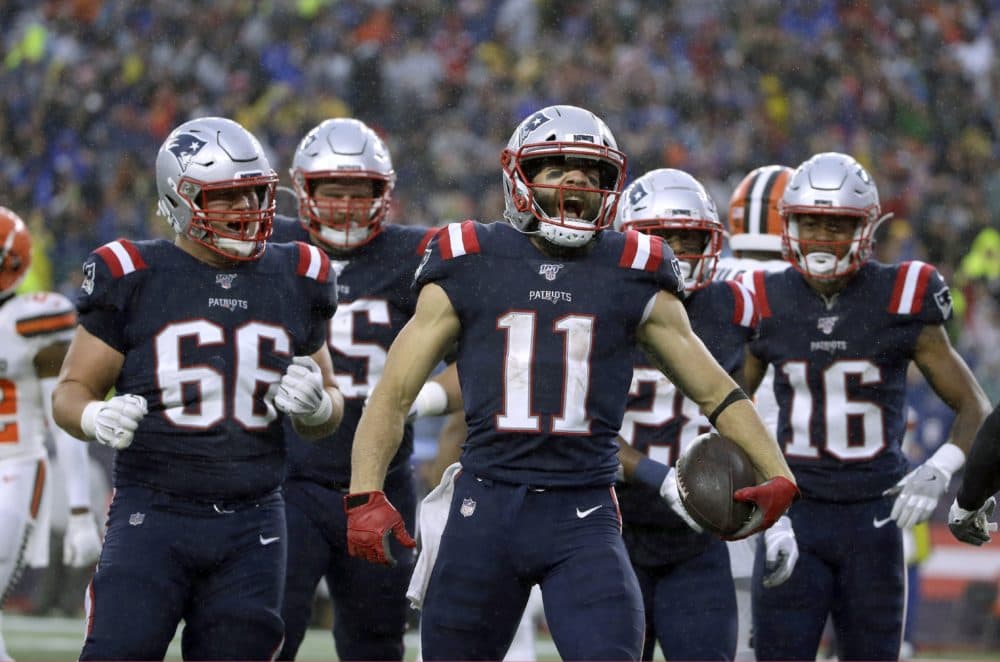 Patriots wide receiver Julian Edelman, center, celebrates his touchdown catch with teammates. (Steven Senne/AP)