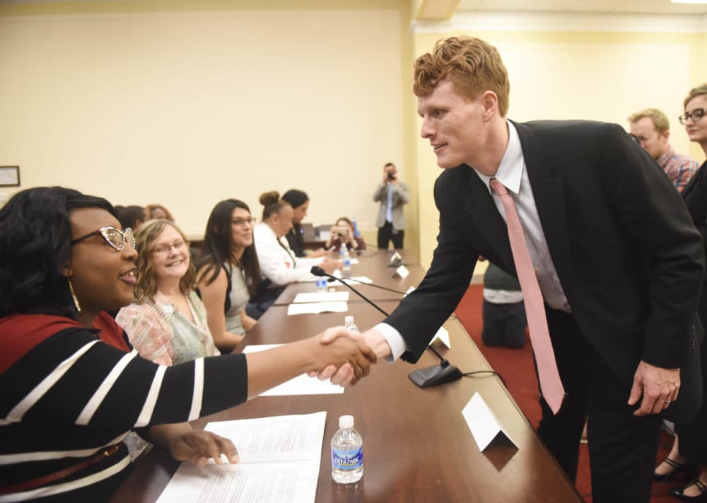 Rep. Joe Kennedy III shakes hands with LaLa Zannell with Anti-Violence Project, at the Congressional Forum on Violence Against the Transgender Community on Nov. 17, 2015. (Kevin Wolf/AP Images for Human Rights Campaign)