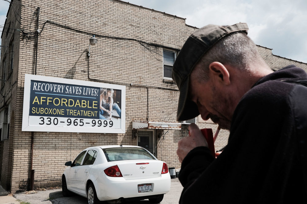 A man walks by a billboard for a drug recovery center in Youngstown on July 14, 2017 in Youngstown, Ohio. (Spencer Platt/Getty Images)