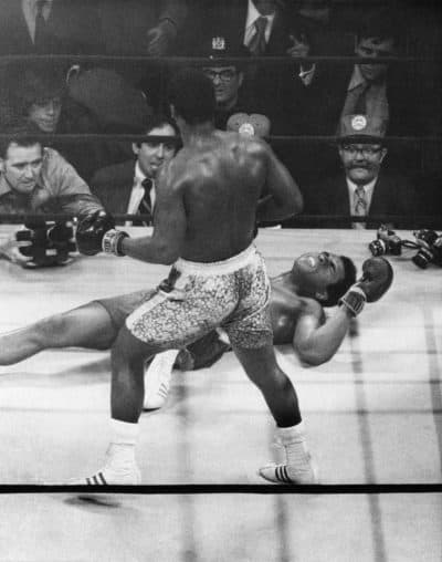 Muhammad Ali lies on the canvas after being knocked down by Joe Frazier in the 15th round of 1971's &quot;Fight of the Century.&quot; (AP)