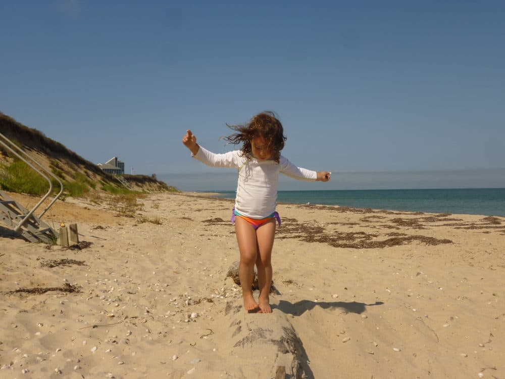 Mila Makovec walks on a beach as a young child before she was diagnosed with Batten disease, a rare genetic disorder. (Courtesy of Julia Vitarello)