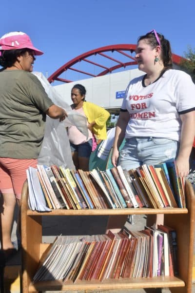 Volunteers with Team Brownsville next to a trolley full of picture books that they read to children during Sunday classes. (Courtesy Paul Goyette)