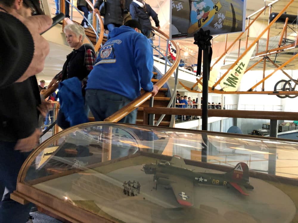 Visitors at the Collings Foundation's American Heritage Museum in Hudson file past a model of the B-17 that crashed in October. (Callum Borchers WBUR)