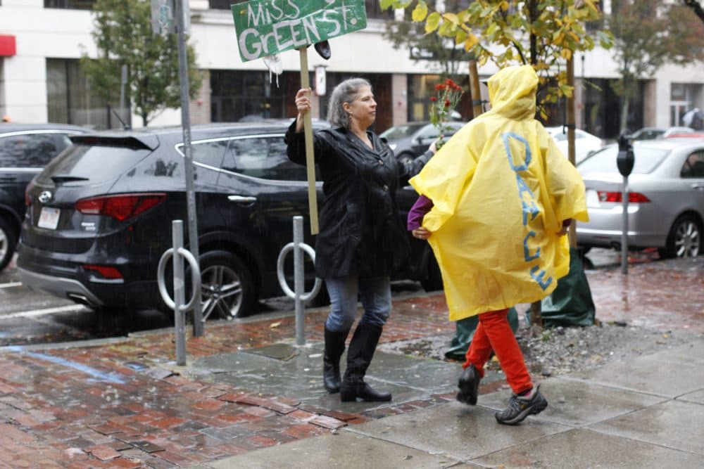 Demonstrators embraced each other and offered warm smiles to passersby, telling anyone who stopped to listen about the loss of community they’ve felt each time one of Central Square’s beloved spaces closes. (Jenn Stanley for WBUR)