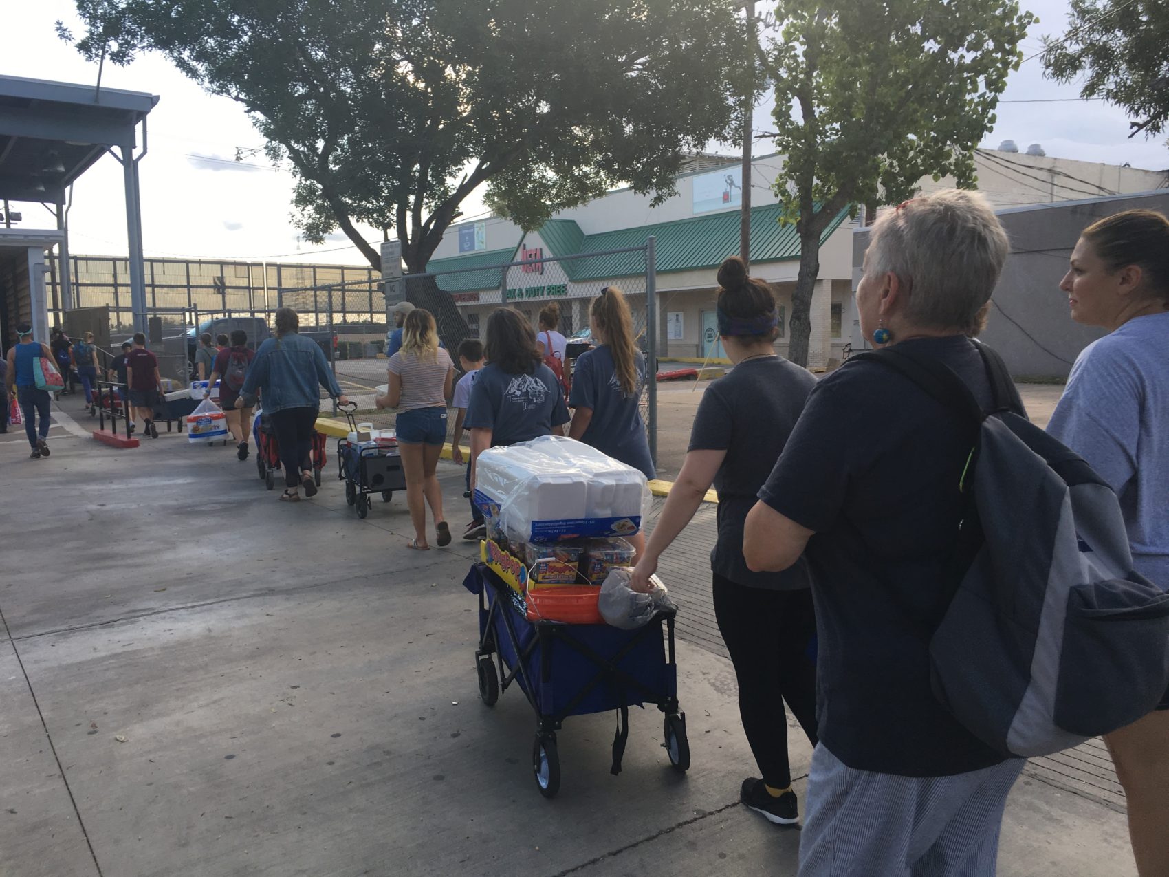 Volunteers with Team Brownsville pull wagons filled with food, water, and other supplies to Matamoros, Mexico.