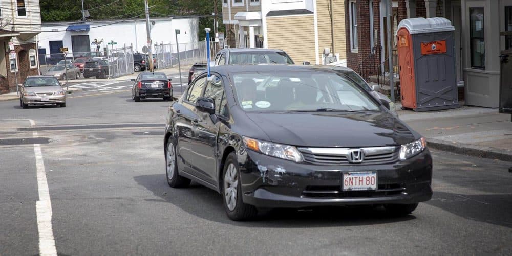 Rev. Vernon K. Walker of Communities Responding to Extreme Weather (CREW) drives his car through East Boston, with the heat sensor in place in the window. (Robin Lubbock/WBUR)