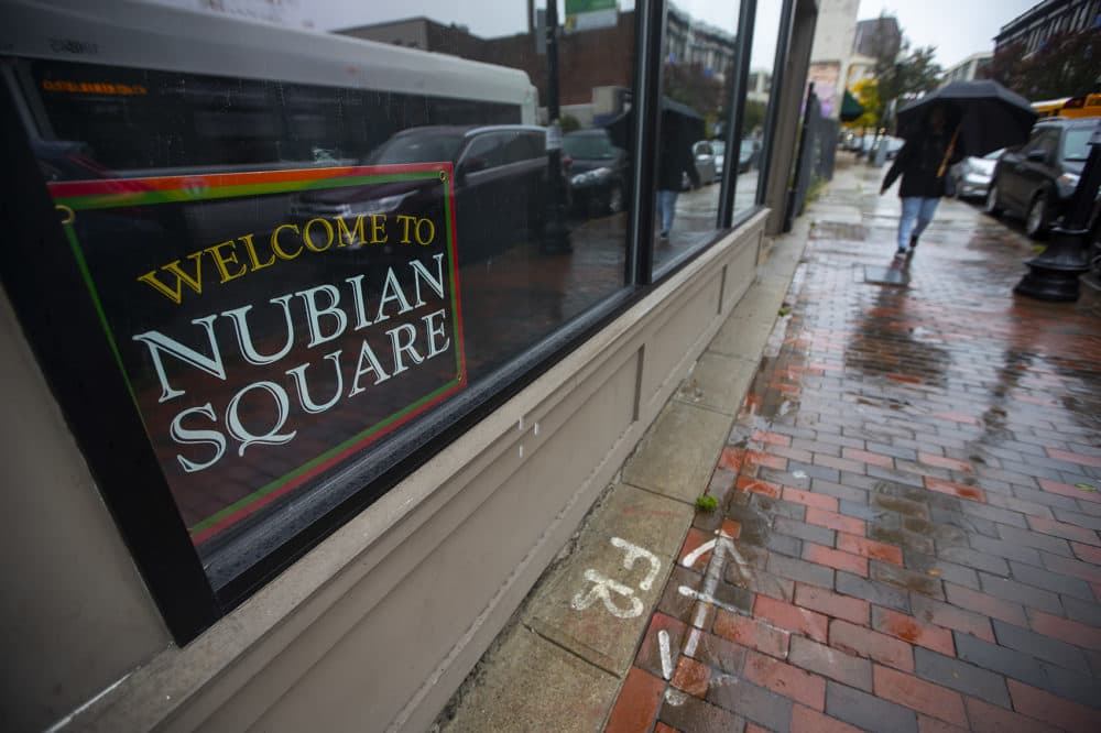 A “Welcome to Nubian Square” sign on display in the window of the Black Market on Washington St. (Jesse Costa/WBUR)