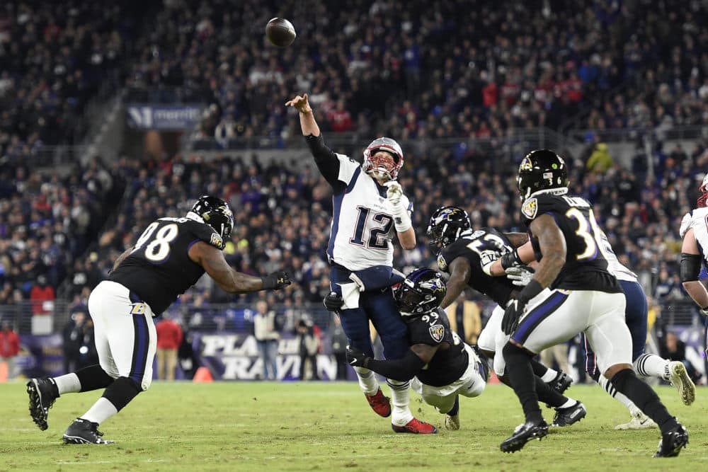 New England Patriots quarterback Tom Brady attempts a pass as Baltimore Ravens linebacker Matthew Judon makes a hit during the first half of an NFL football game Sunday in Baltimore. (Gail Burton/AP)