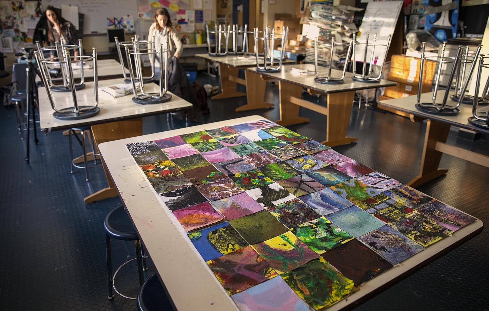 A table covered with a collage of abstract squares in Amanda Davis’ art class. (Robin Lubbock/WBUR)