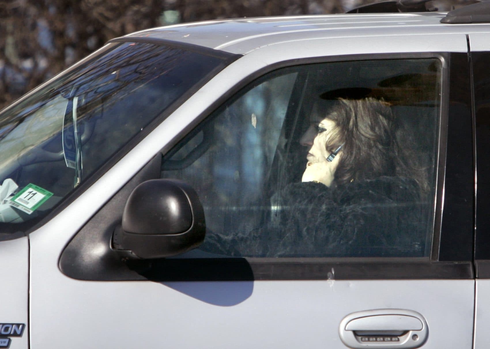 A driver talks on a cell phone while driving in Newark, N.J. in 2008. (Mike Derer/AP)