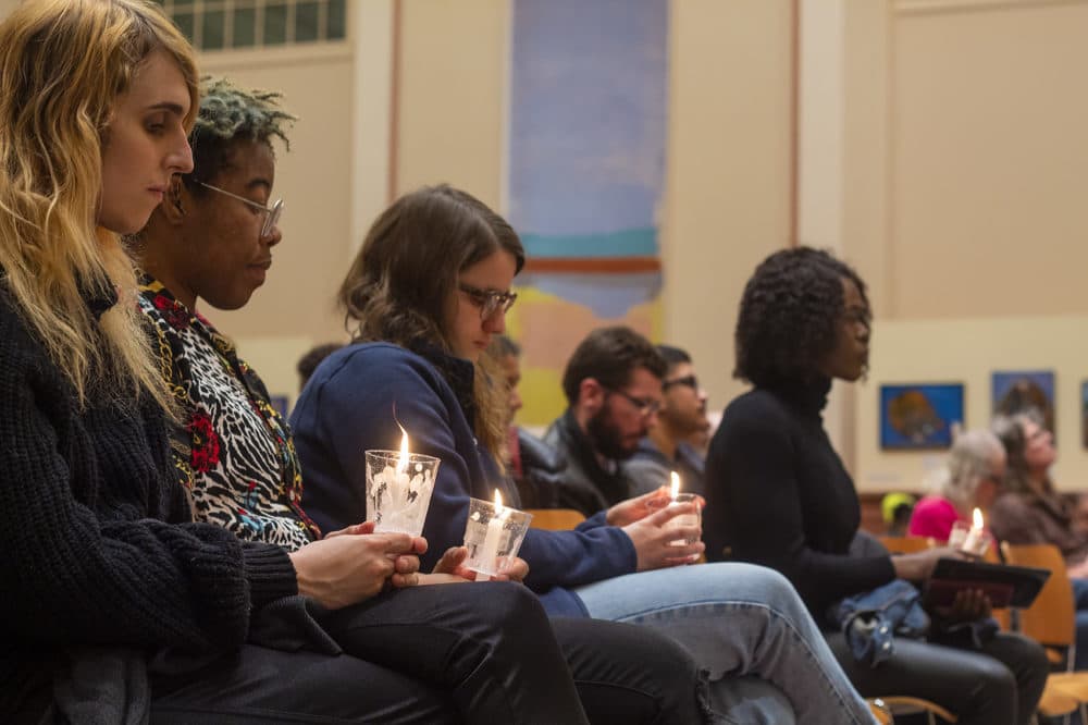Participants hold candles during the Transgender Day of Remembrance gathering at the Cathedral of Saint Paul on Sunday. (Quincy Walters/WBUR)